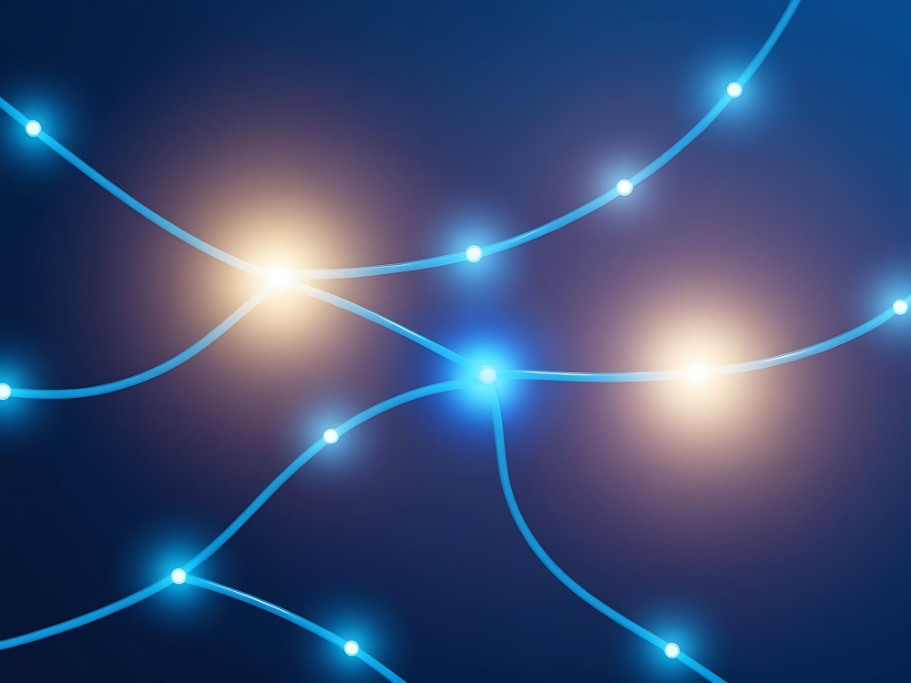 Red de nodos conectados por líneas de luz que representa cómo los sistemas de inteligencia artificial interpretan las relaciones entre contenidos para identificar una organización como referencia en su territorio.